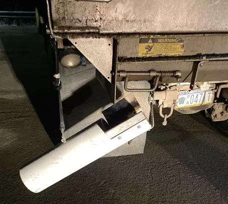 An image of a PVC chute prototype mounted to the rear of a PennDOT dump truck.